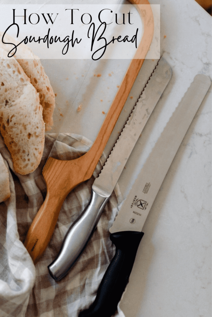 Three bread knives on white countertop and gray and white checkered tea towel 