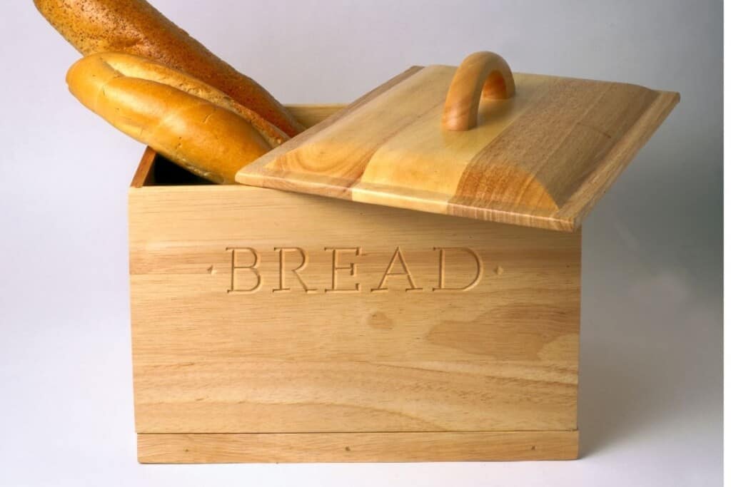 Wooden bread box with french bread loaves sticking out