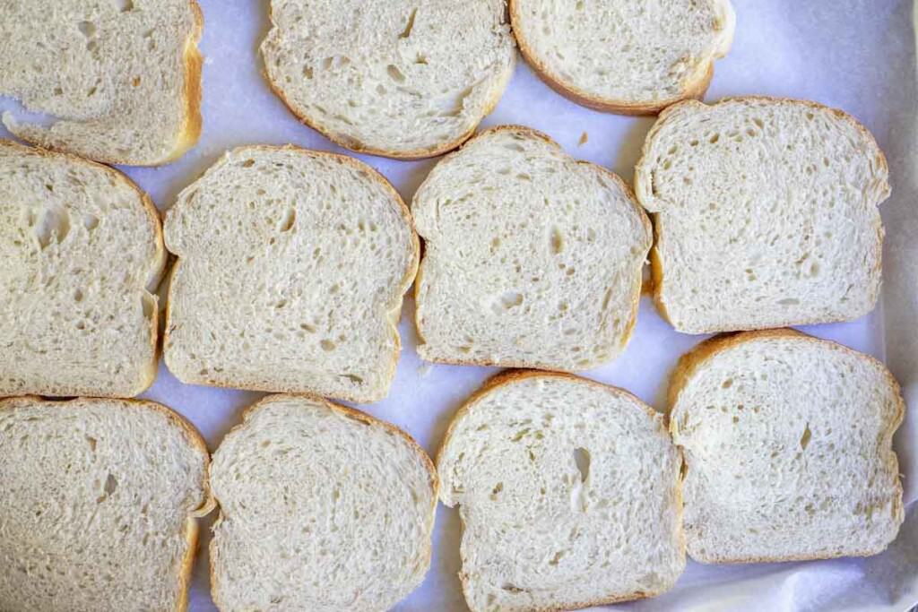 sliced bread on a parchment lined baking sheet