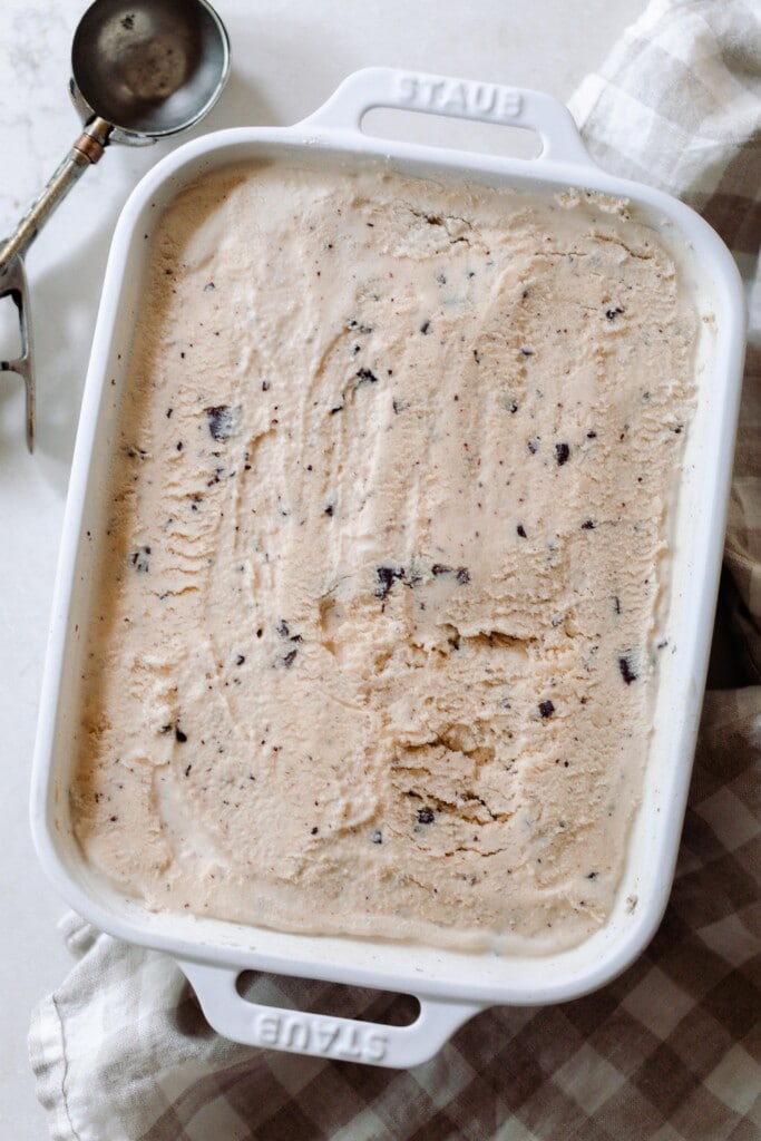 overhead photo of java chip ice cream in a white baking dish on a white countertop