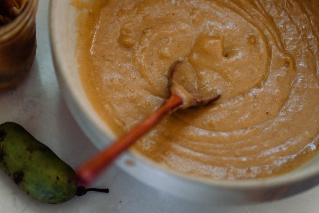 paw paw puree and butter in a stone bowl with a wooden spoon