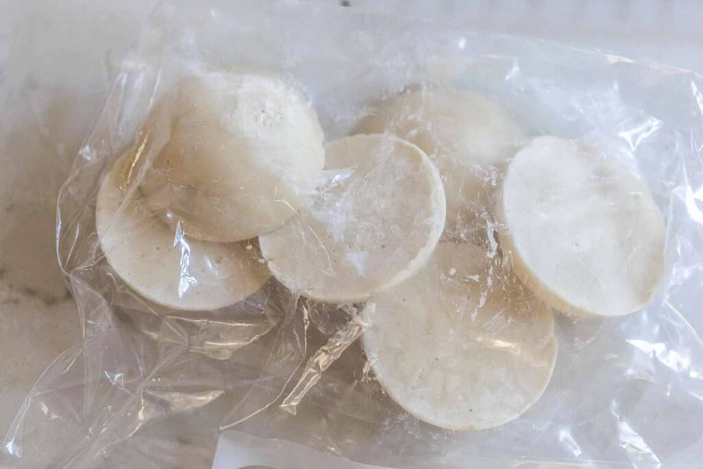 frozen sourdough starter in a plastic bag on a countertop