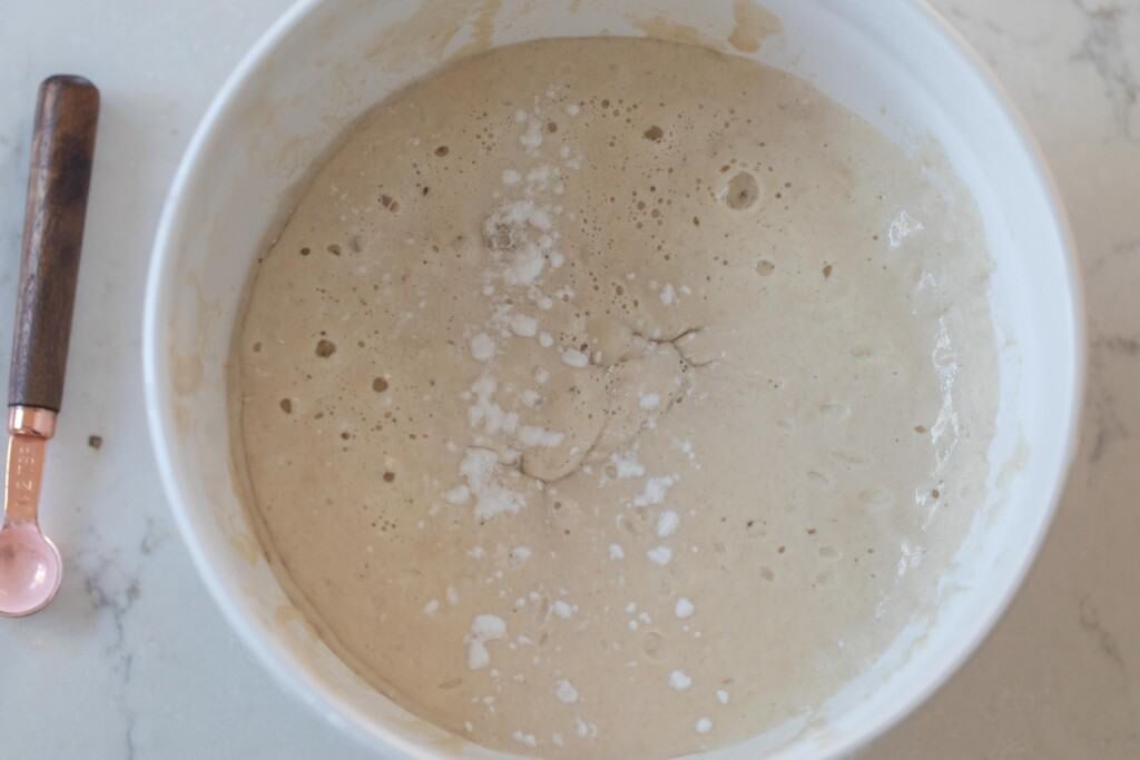 baking soda added to batter in a stoneware bowl