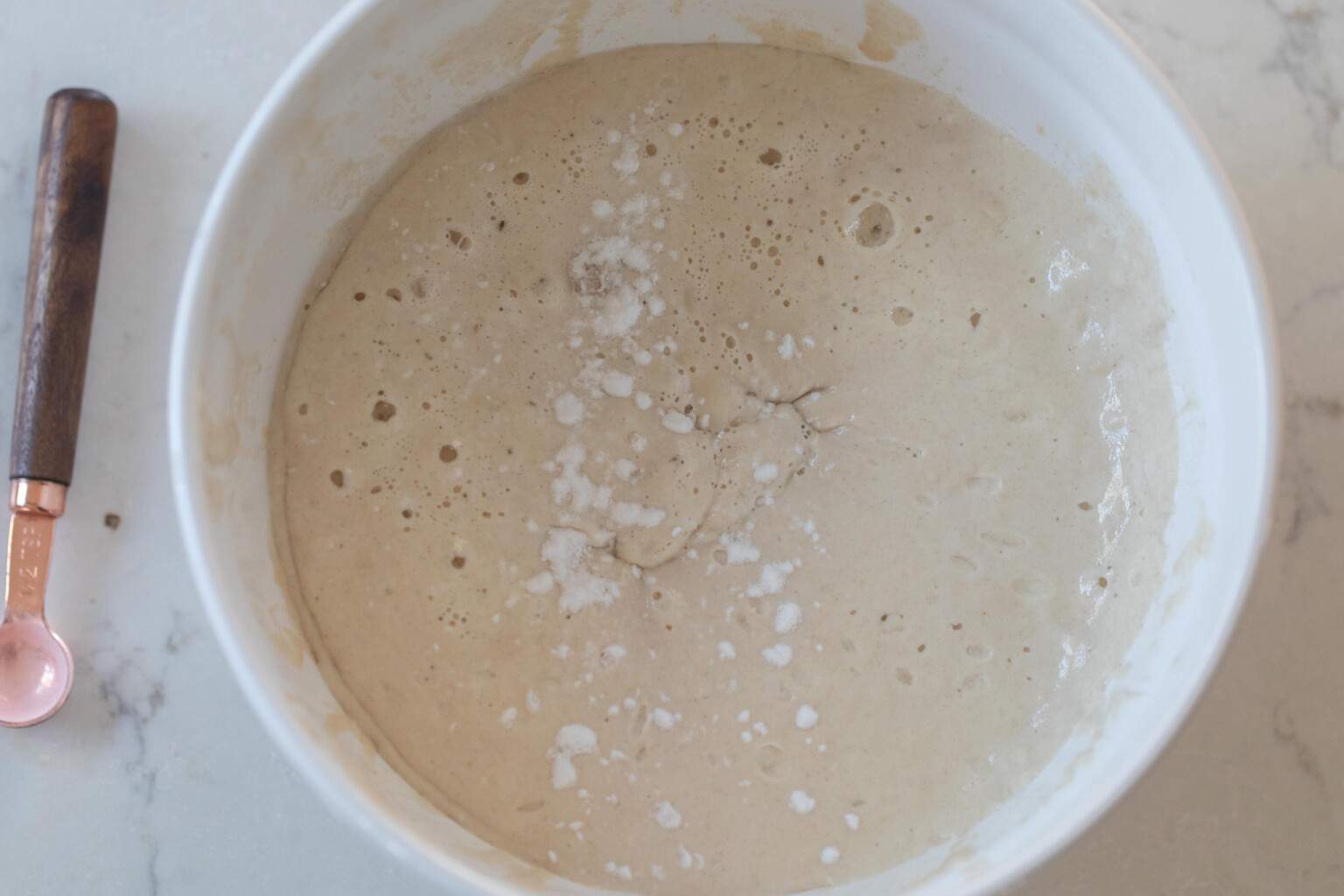 Baking soda added to batter in a bowl.