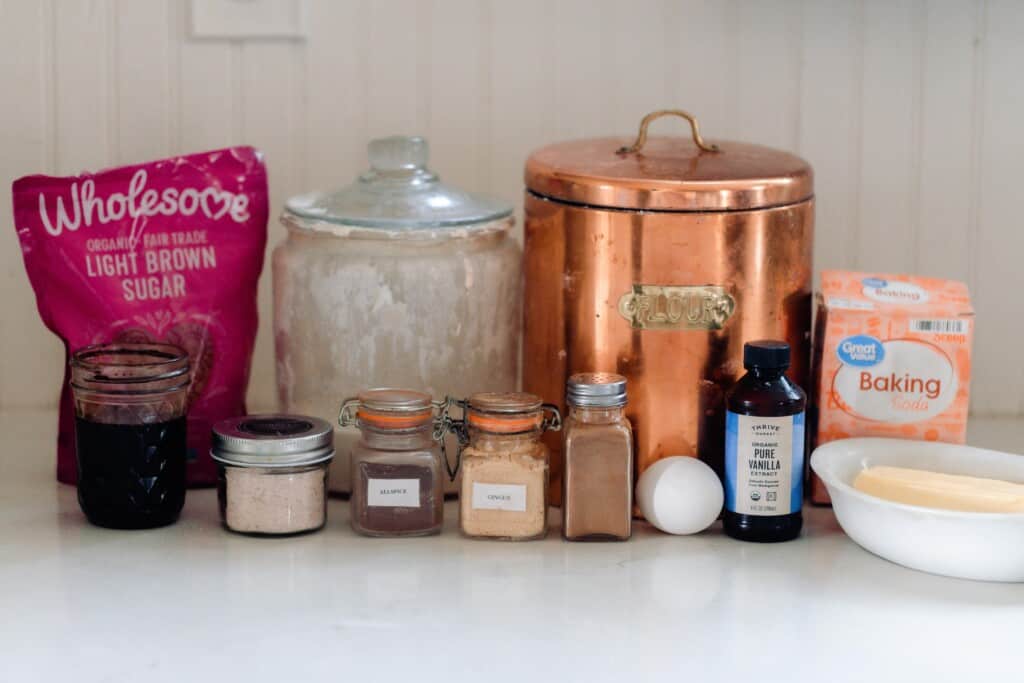 jars, canisters, and bags of ingredients on a white countertop