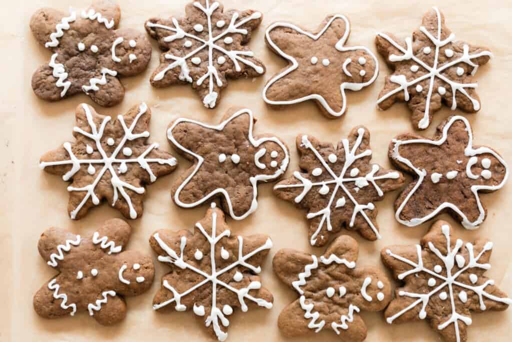 Sourdough gingerbread men and snowflakes on parchment paper