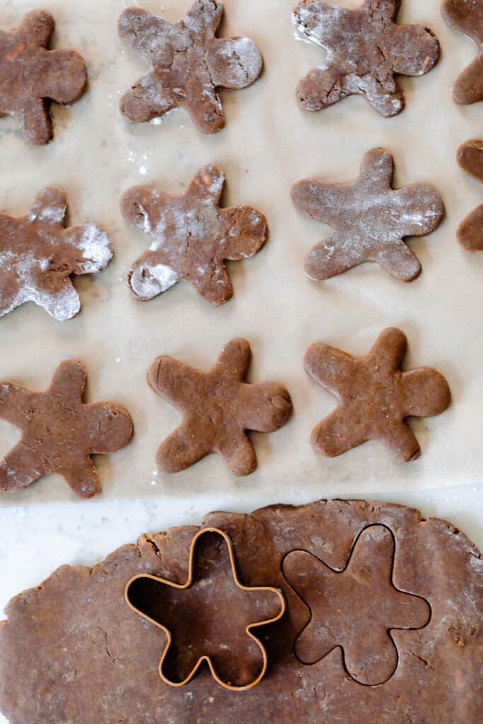 cutting out sourdough gingerbread cookie dough on a quartz counter