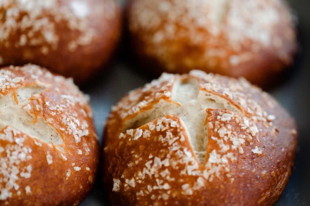 close up of four sourdough pretzel buns