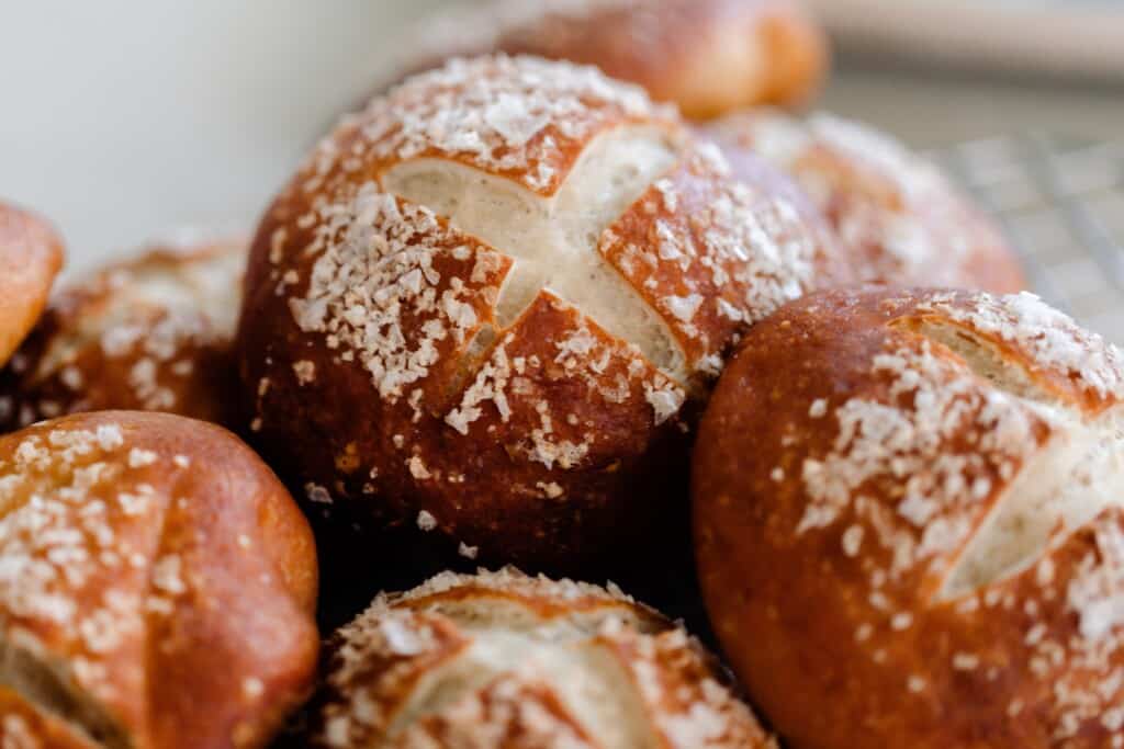 sourdough pretzel buns stacked on top of each other