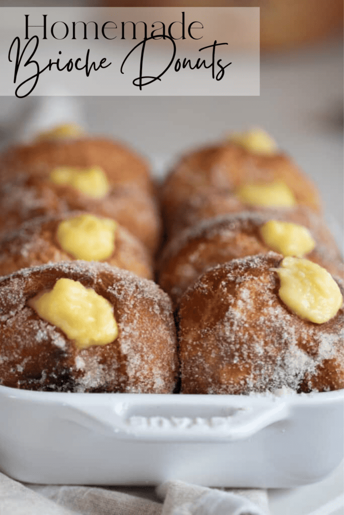 Homemade brioche donuts with custard filling in a white casserole dish