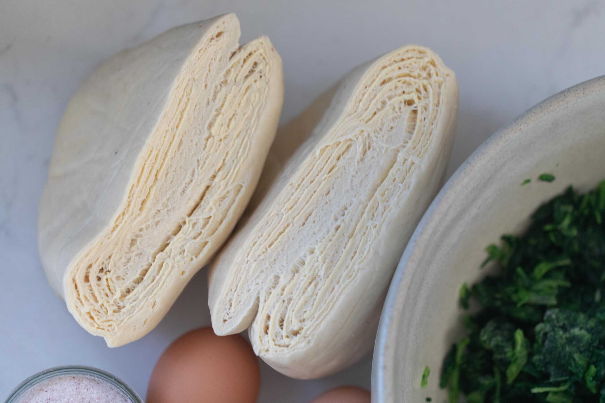 Puff pastry on a white counter.