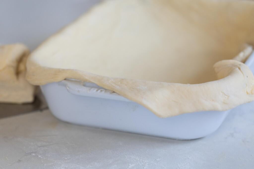 puff pastry rolled out and in a white baking dish