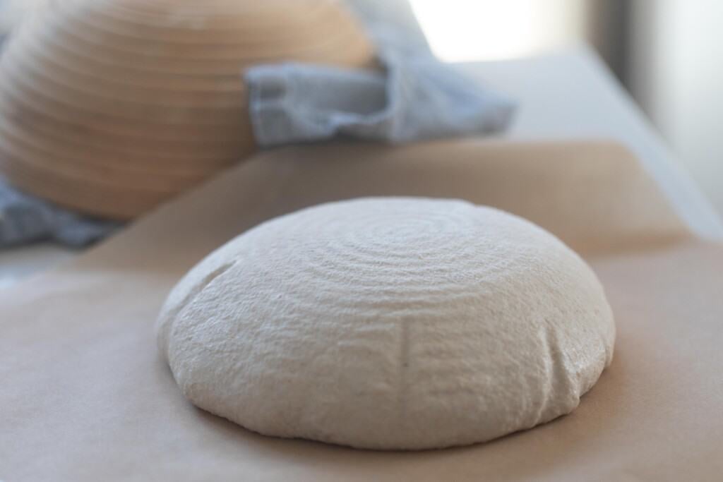 high hydration sourdough bread on parchment paper after second rise and ready to be scored