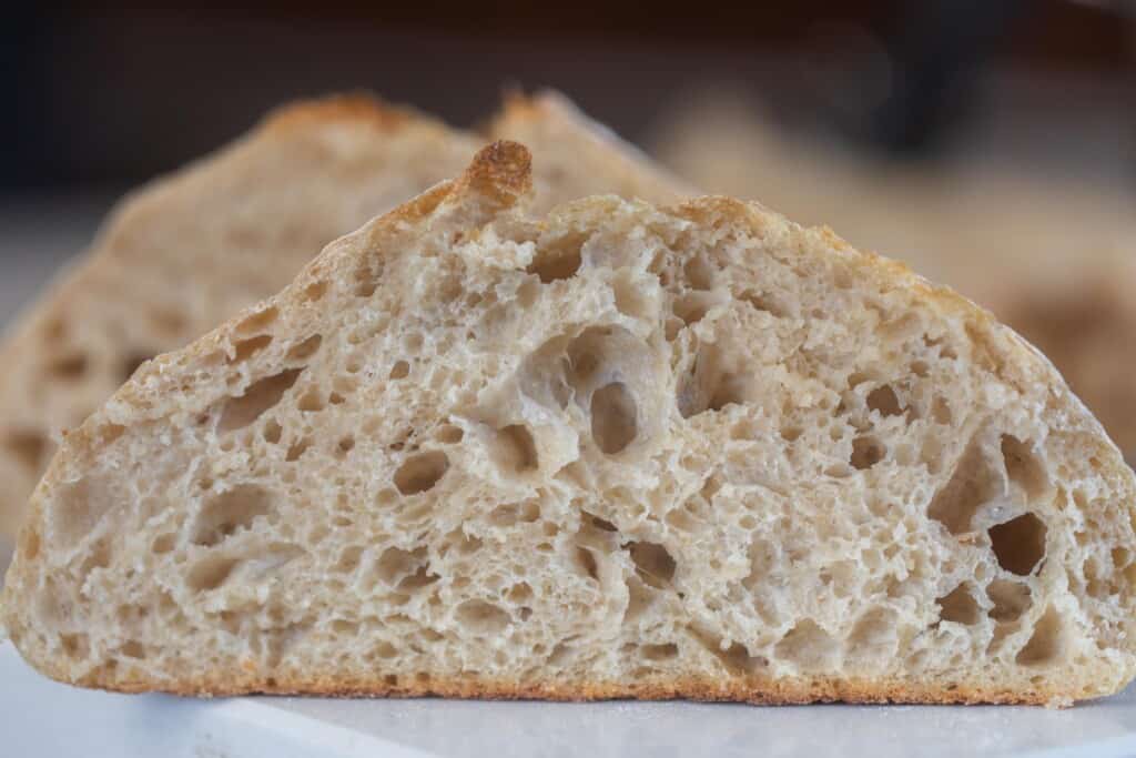 A close up of a slice of high hydration sourdough bread