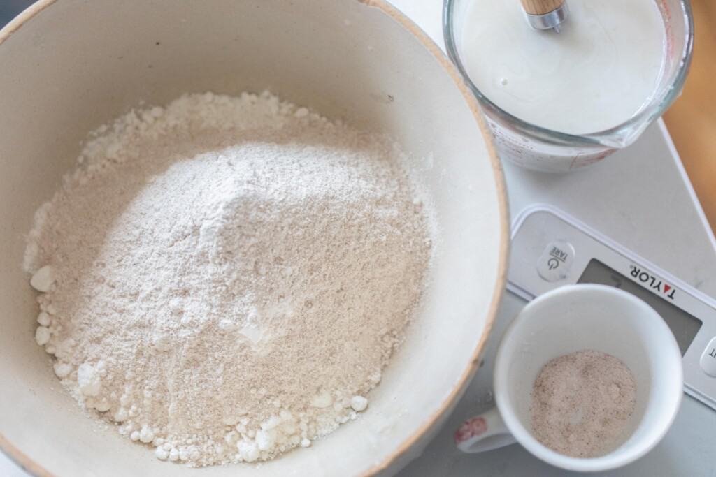 ingredients for honey sourdough bread in white bowls