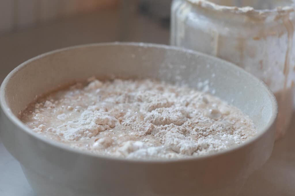 large mixing bowl with ingredients for mini sourdough loaves inside