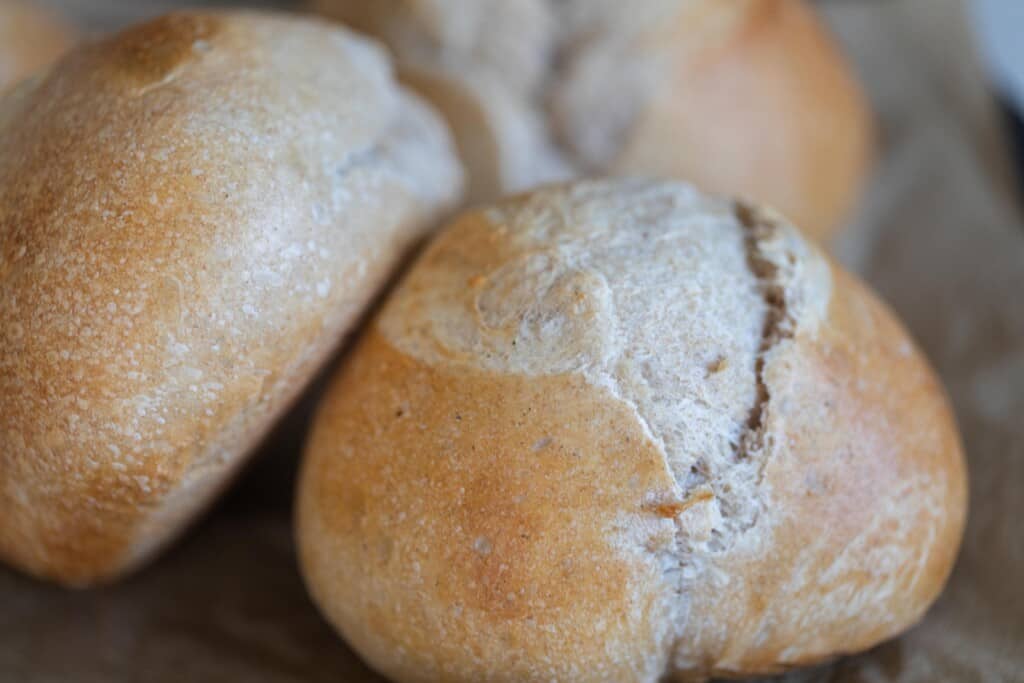 close up of three Mini sourdough loaves on a wodden cutting board