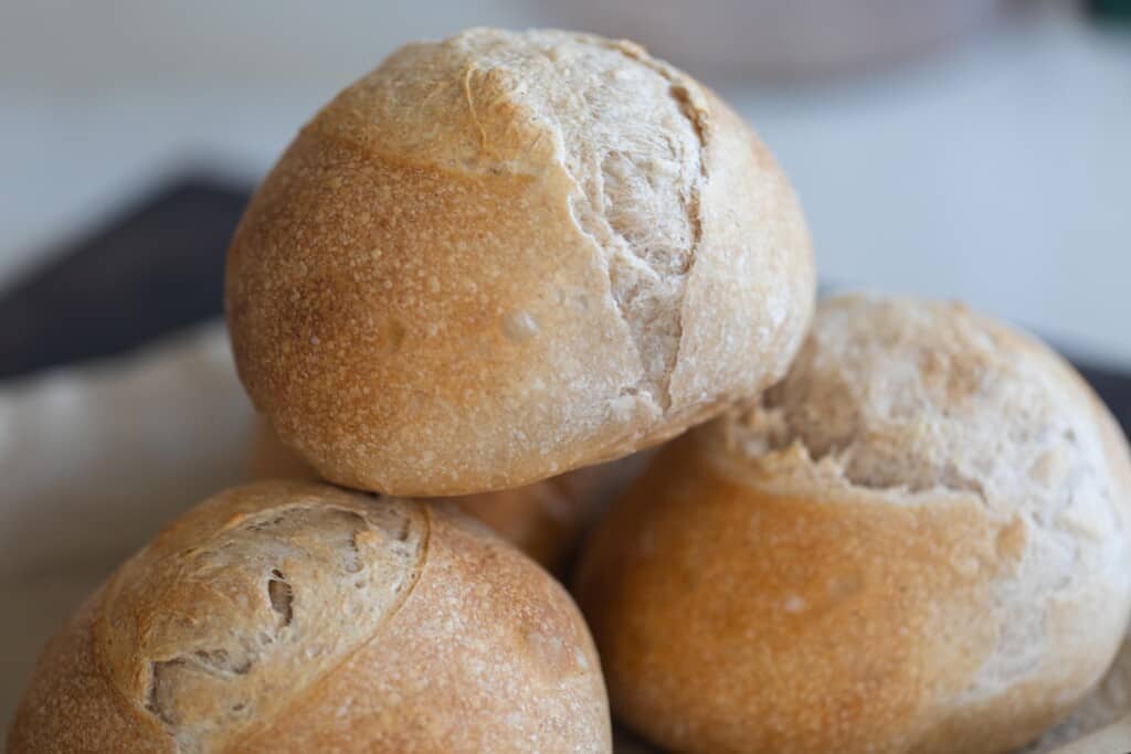 three loaves of mini sourdough bread stacked on each other