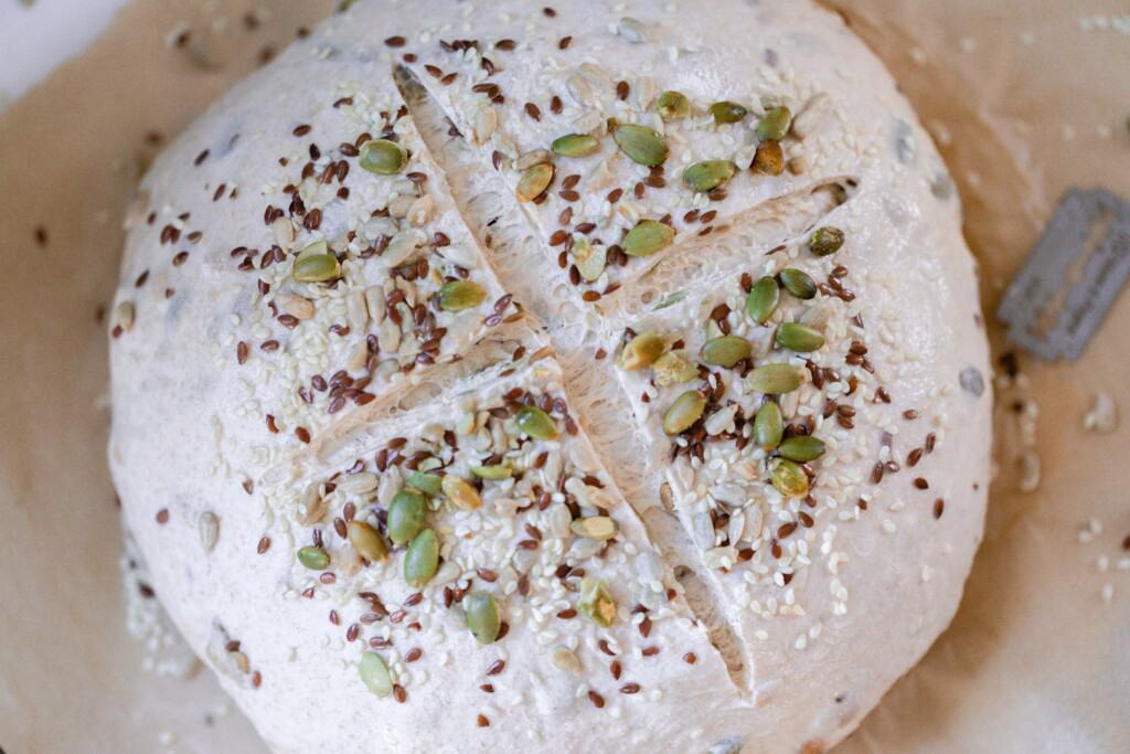 Seeded sourdough loaf scored and ready for the oven