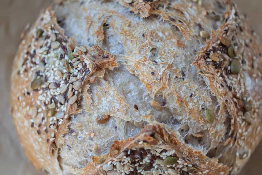 Close up of the top of a freshly baked seeded sourdough bread