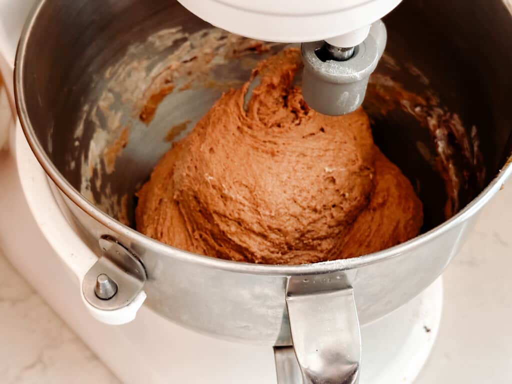sourdough brown bread dough being mixed in a stand mixer