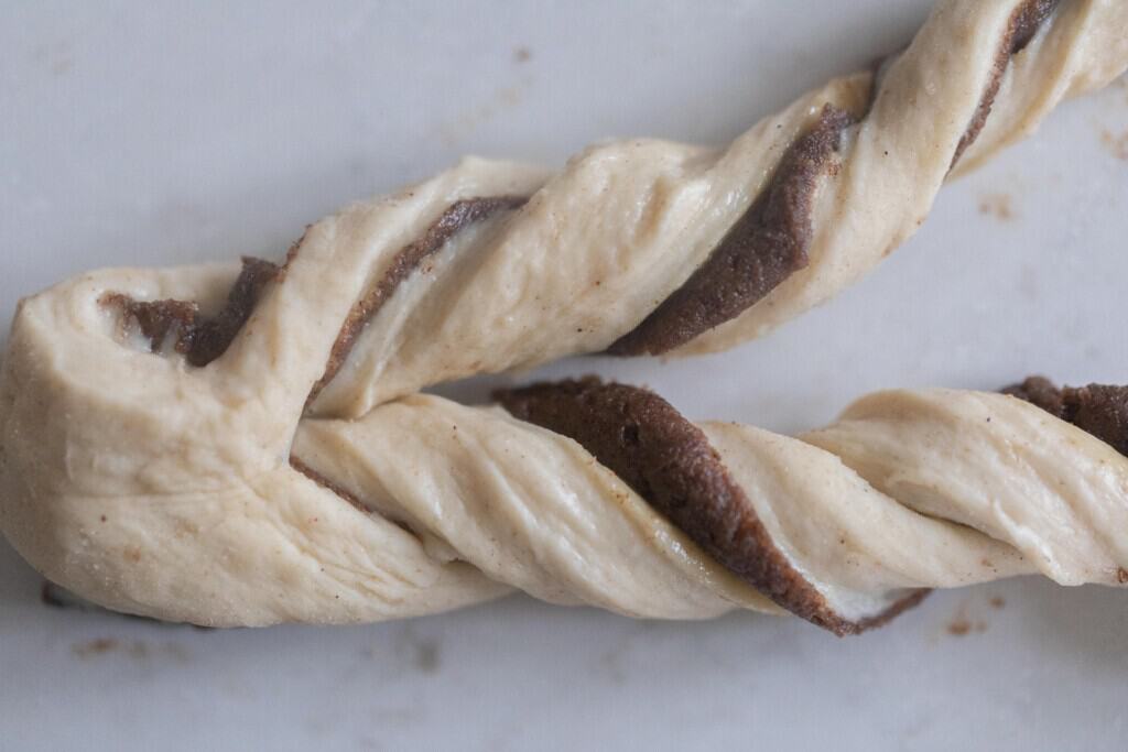 sourdough Swedish cinnamon dough twisted on a white countertop 