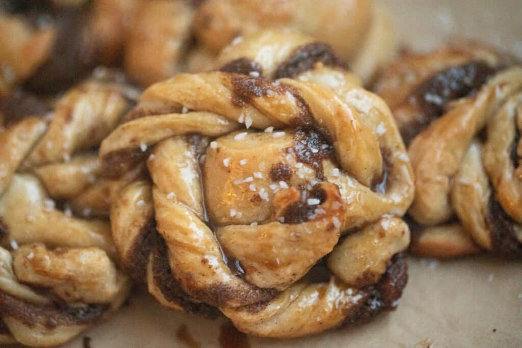 sourdough Swedish cinnamon buns stacked on parchment paper