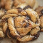 sourdough Swedish cinnamon buns stacked on parchment paper