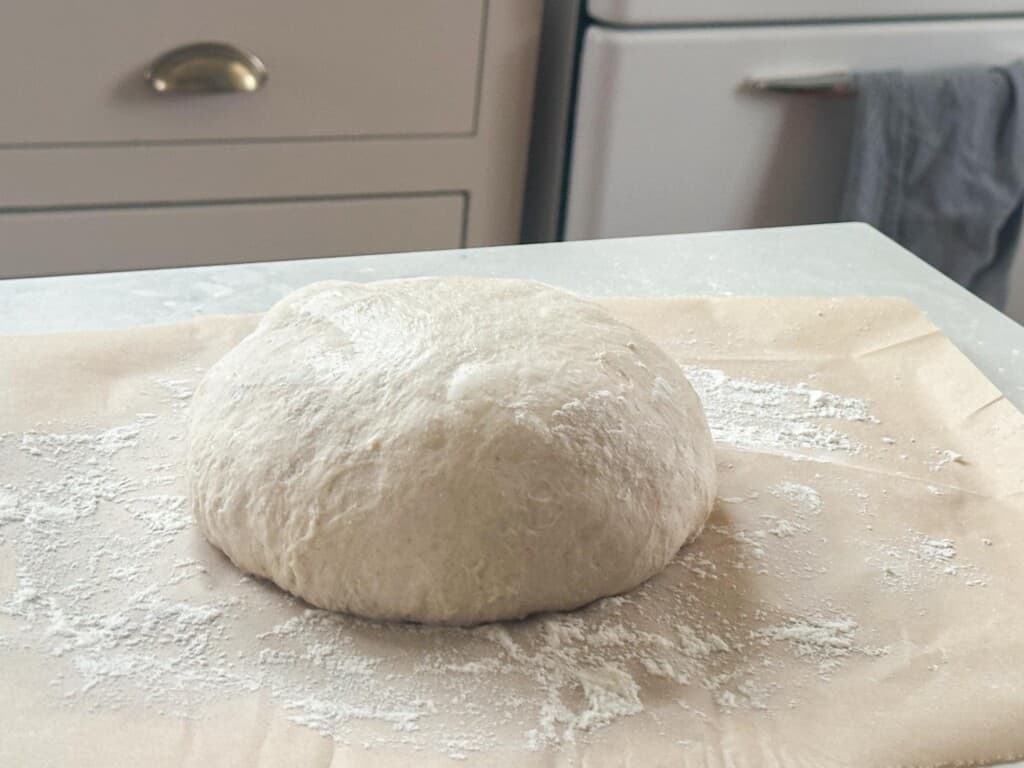 Shaped sourdough bread on a floured counter top