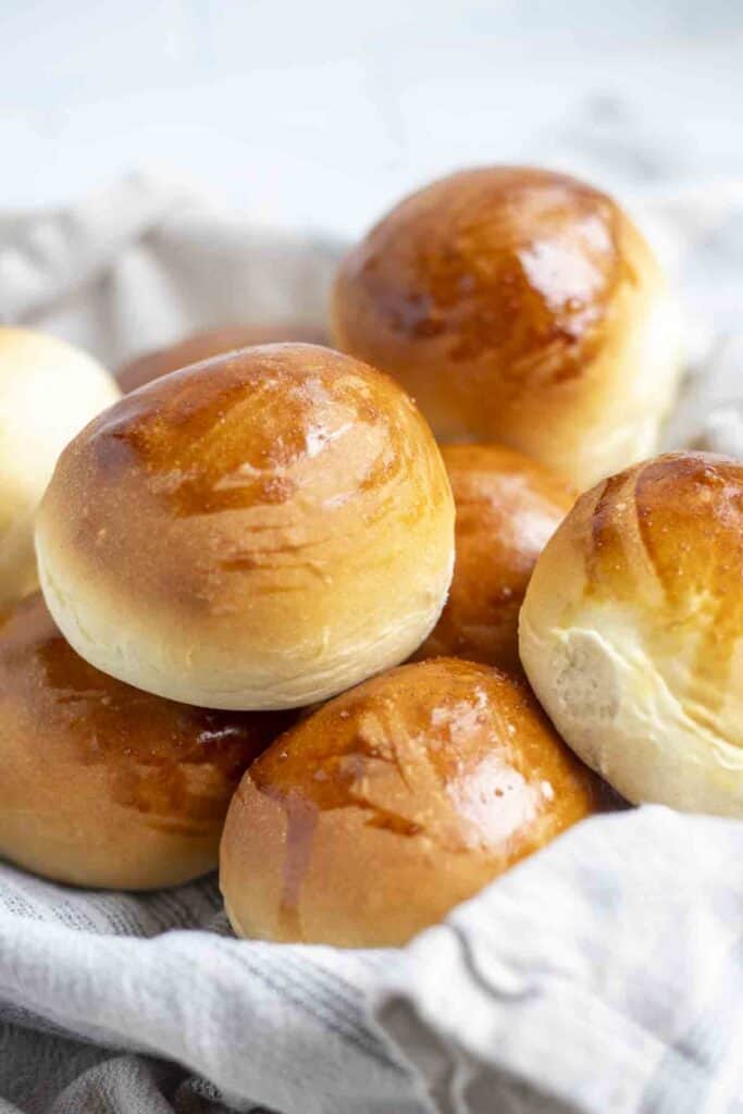 a close tip of sourdough discard rolls in a towel lined dish