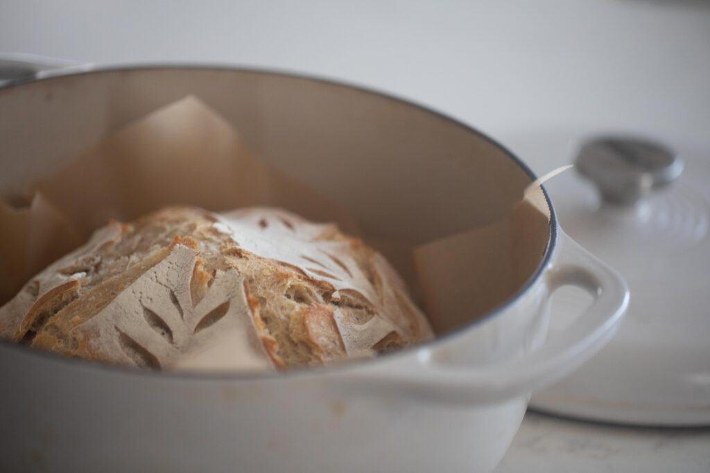 baked sourdough loaf in a dutch oven 
