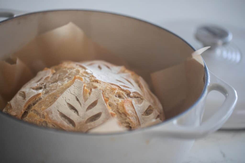 sourdough loaf in a white dutch oven