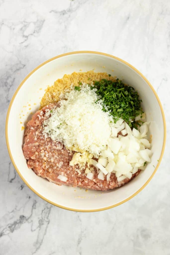 pork sausage, onions, parsley, breadcrumbs, garlic, in a large bowl