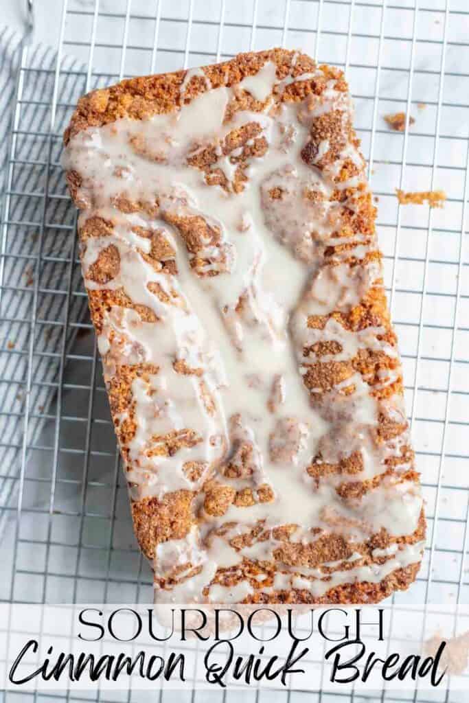 overhead photo of sourdough cinnamon quick bread topped with icing on a cooling rack