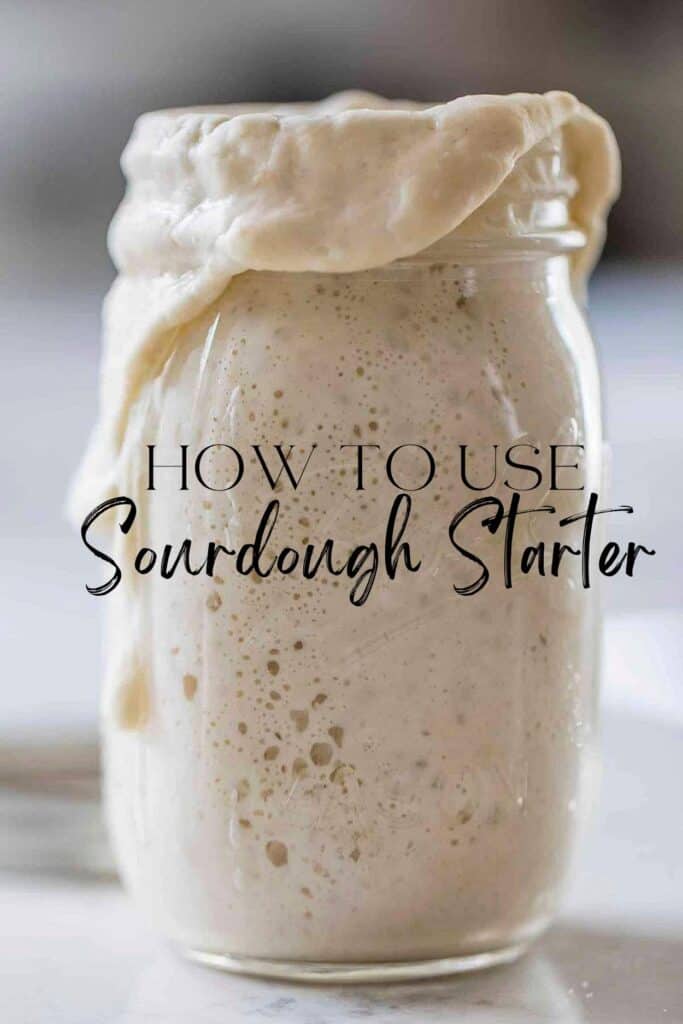 bubbly overflowing sourdough starter a white countertop