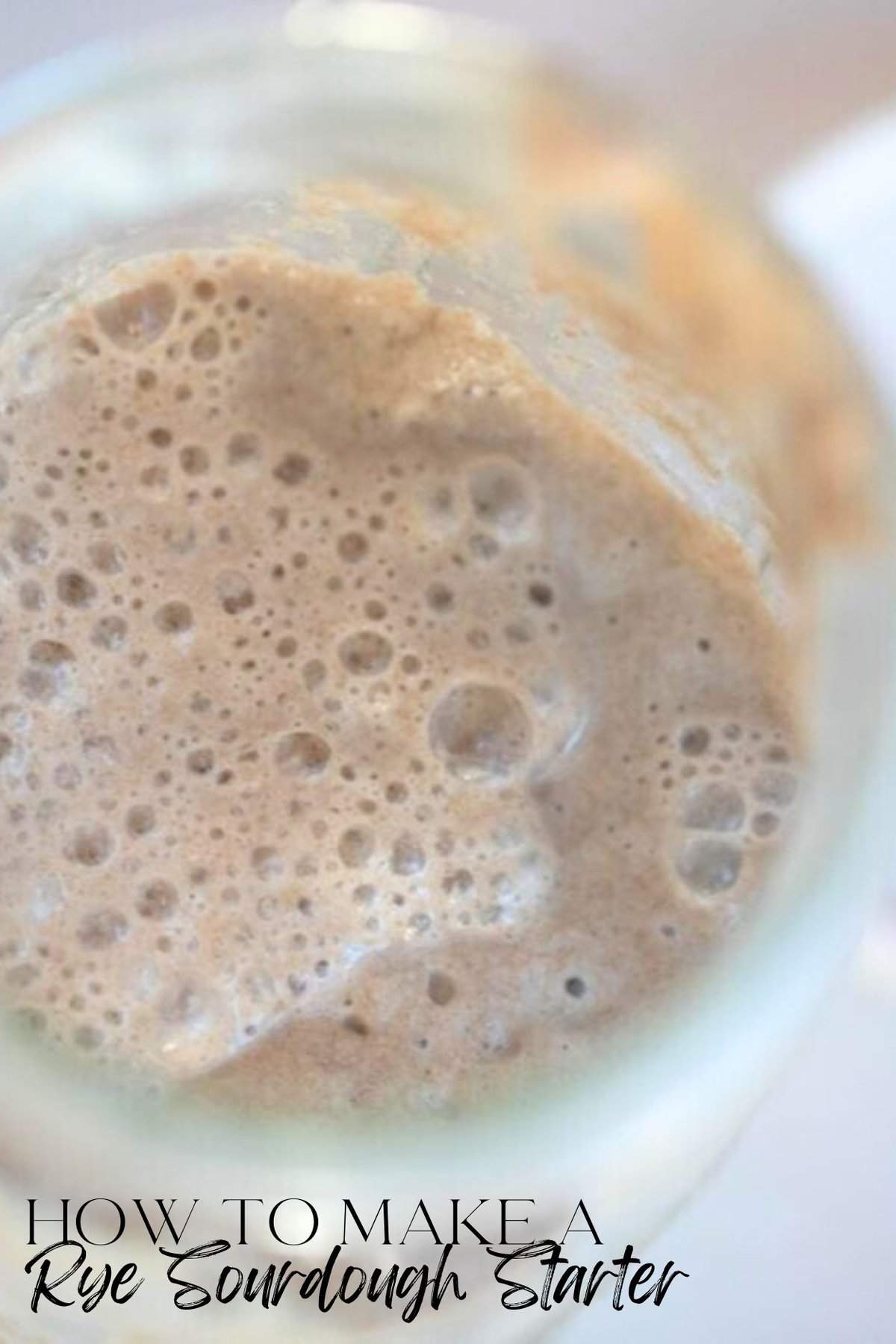 Close up picture of a rye sourdough starter in a glass mason jar.
