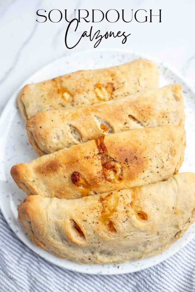 four calzones on a white and blue spotted beacon on marble countertop