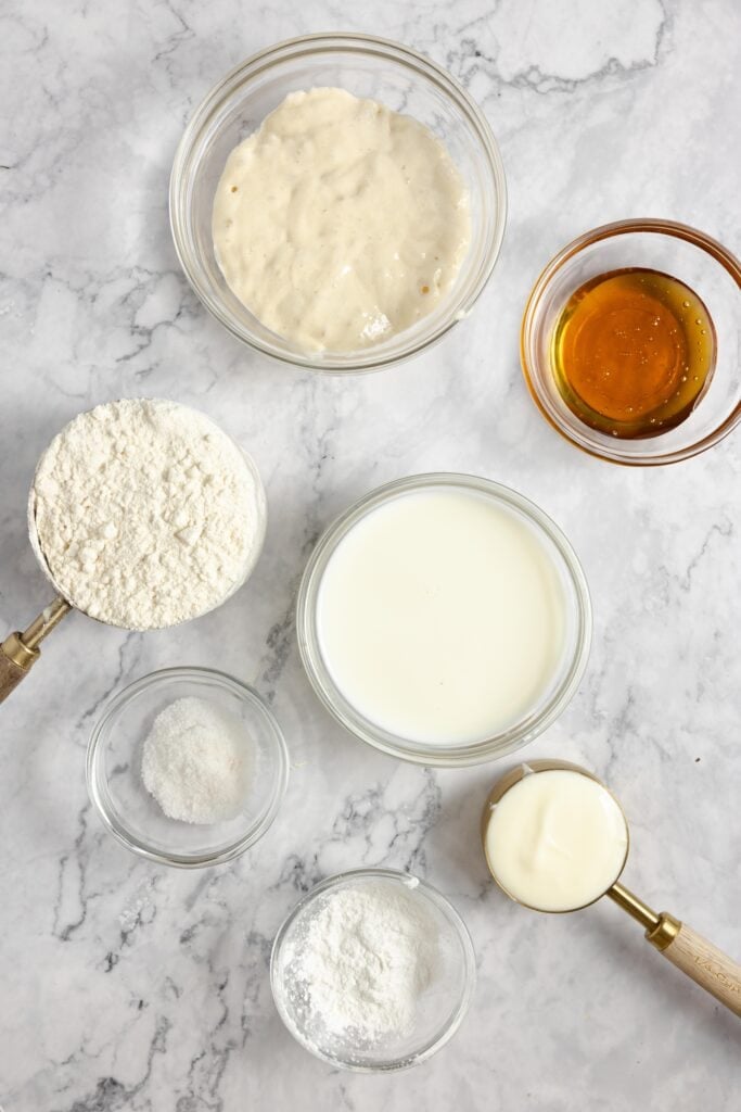 sourdough naan ingredients on a white countertop