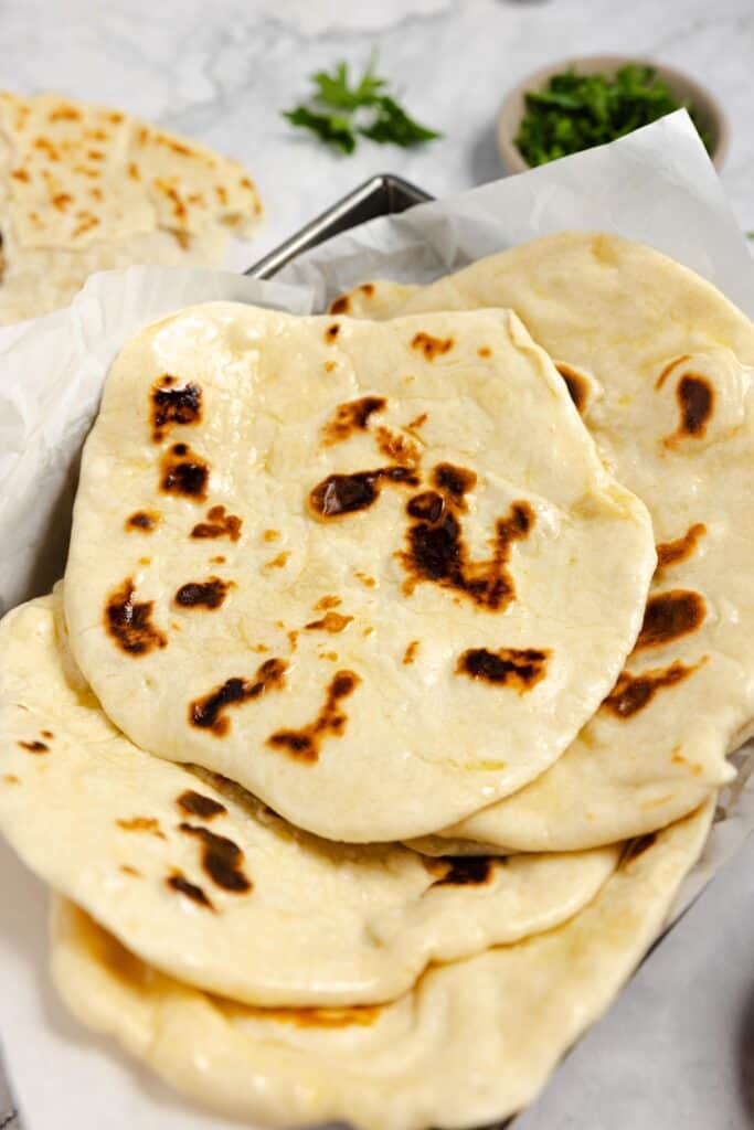 sourdough naan piled on top of each other