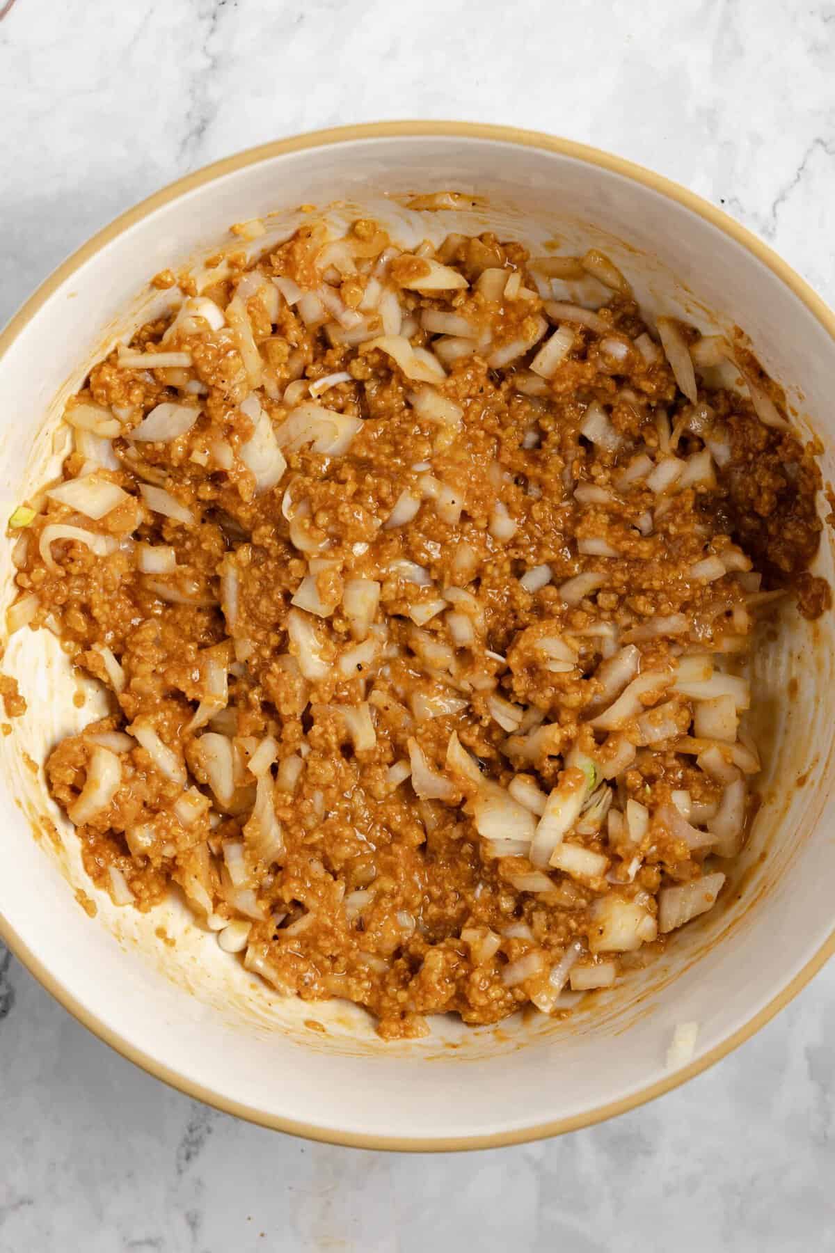 the ingredients for meatloaf mixed together in a large bowl before ground beef is added