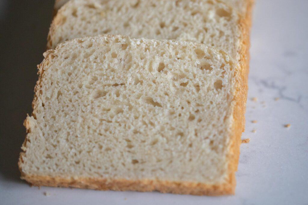 Close up of a slice of pain de mie bread on a white countertop