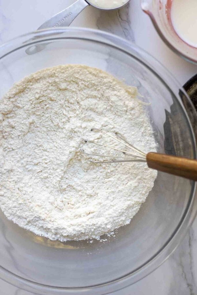 sourdough cheddar biscuits dry ingredients whisked together in a large glass bowl