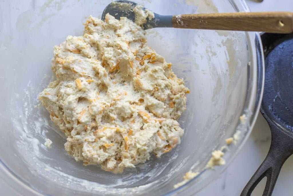 Sourdough cheddar biscuits mixed together and ready to be scooped out onto a baking sheet