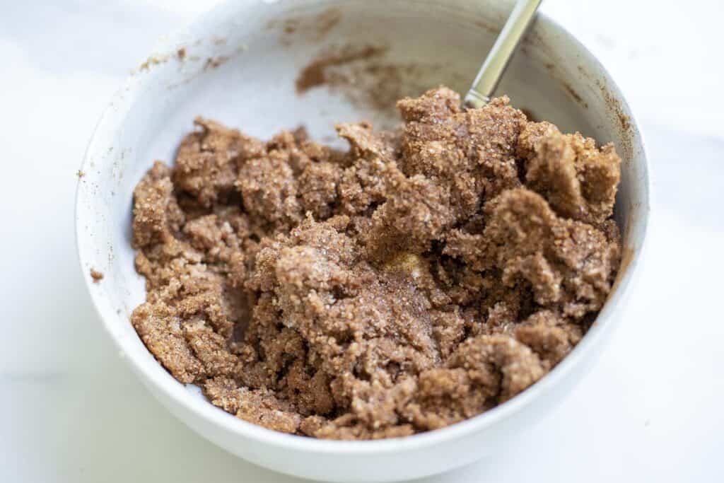 cinnamon sugar filling in a white bowl with a spoon