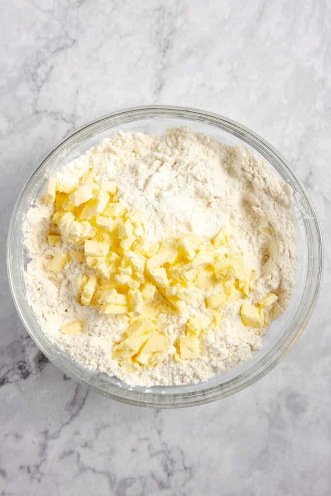 flour and chunks of butter in a glass bowl