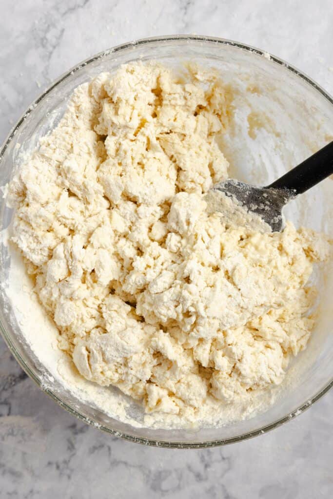 soda bread dough in a glass bowl with a spoon