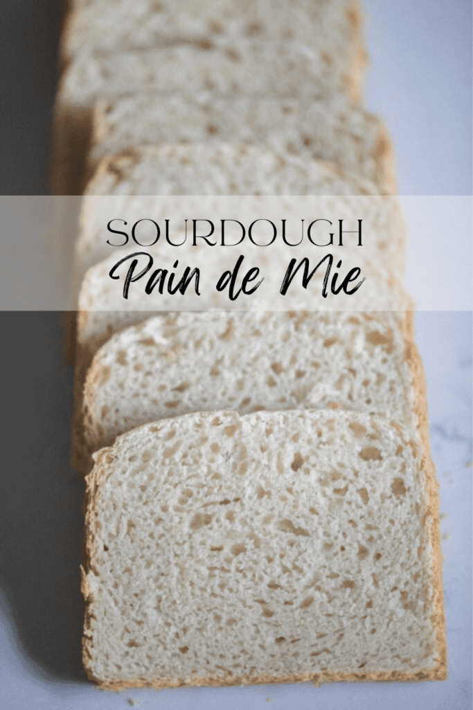 Slices of pain de mie bread layered on top of one another on a white marbled countertop 