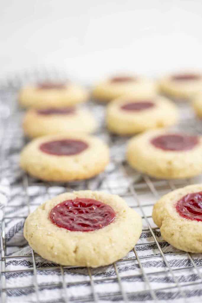 thumbprint cookies with raspberry jam on a wire rack