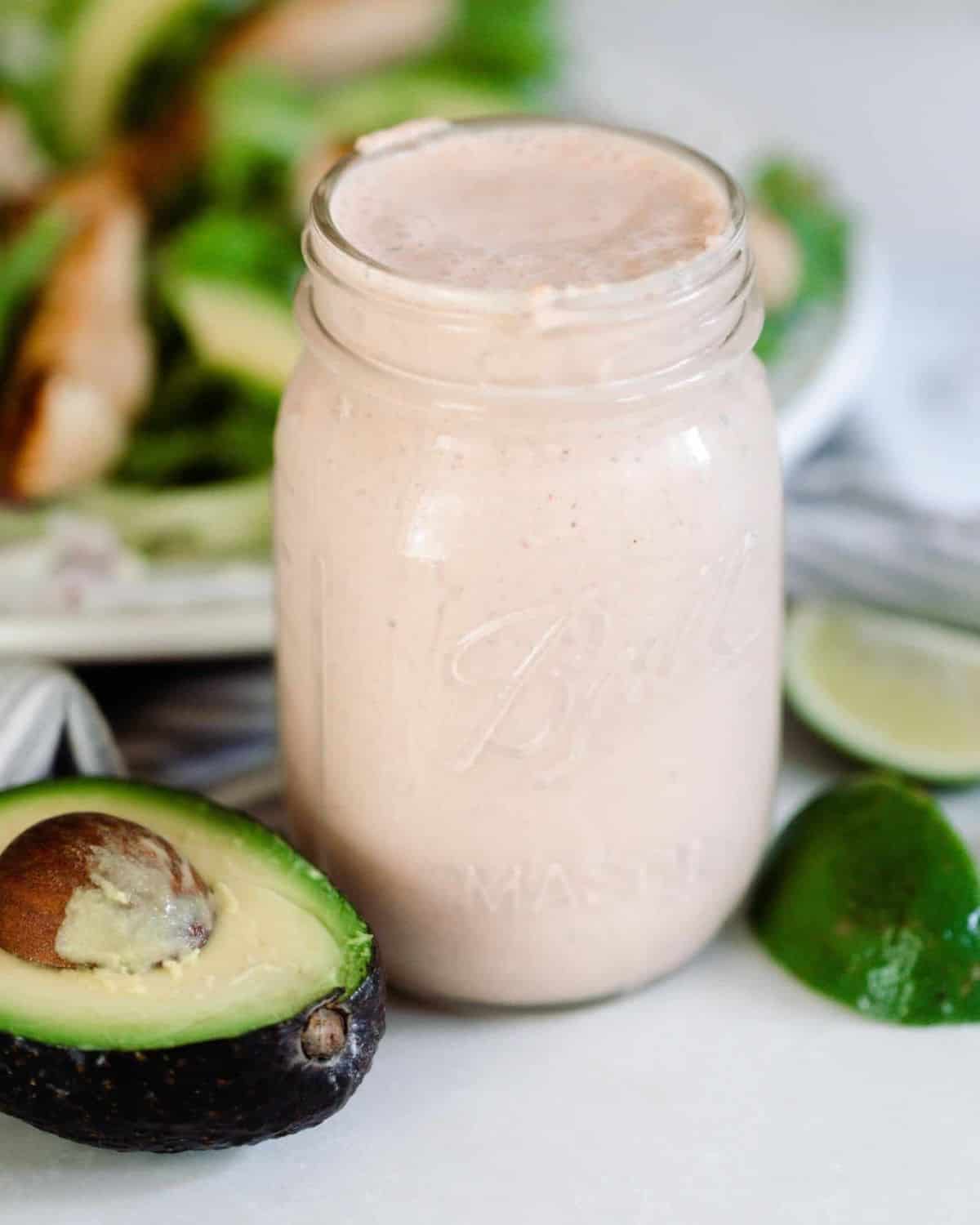 A mason jar filled with Mexican ranch Dressing.