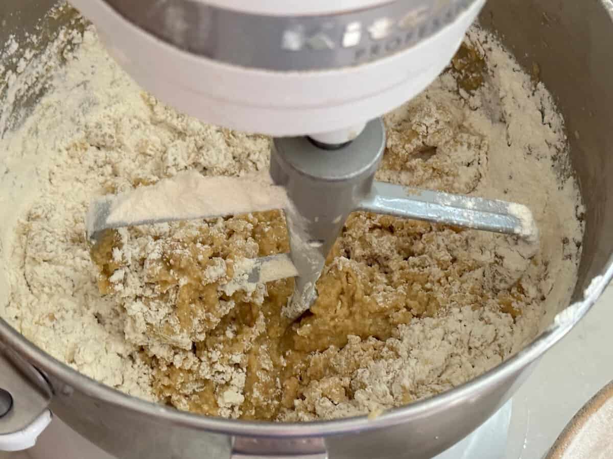 Adding dry ingredients to the wet ingredients.